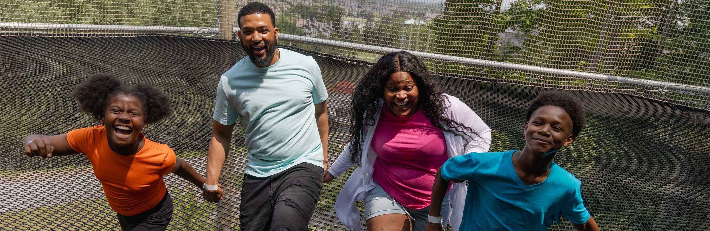a smiling man riding down the Ridge Runner Mountain Coaster