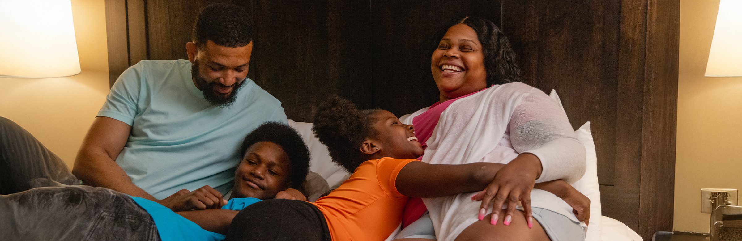A family in their bed at Weider Lodge Village Suite