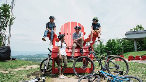 A family of bikers on the Mega Muskoka Chair