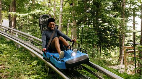 A young woman enjoying the Ridge Runner Mountain Coaster at Blue Mountain Resort