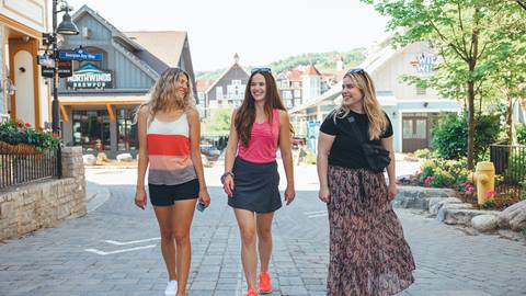 Three women walking around The Village