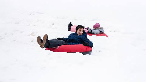 Two kids riding Hike N' Tube at Blue Mountain Resort