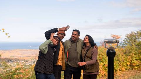 a family taking a selfie at the top of Blue Mountain