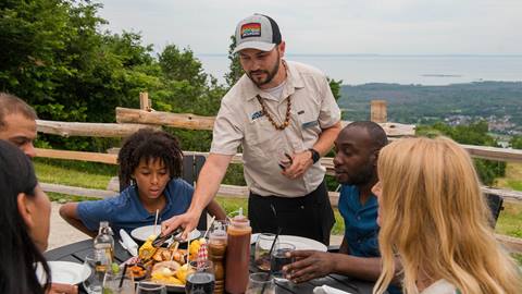 a man serving food to a group of people at Summitview Mountaintop at Blue Mountain Resort