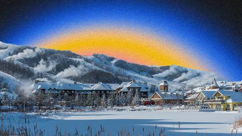 Snowy village with mountains in the background and a gradient sky transitioning from blue to yellow and orange.