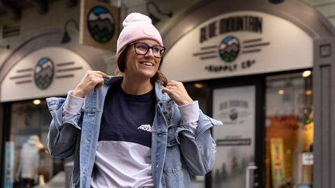 A woman wearing merch from Blue Mountain Supply Co.