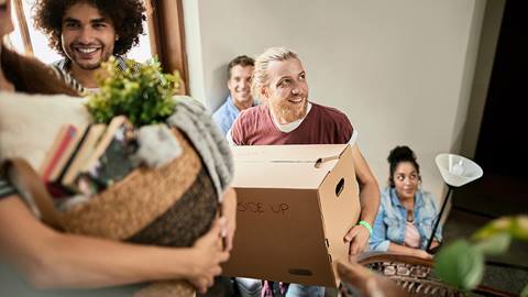 A group of people are moving into a new home.