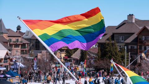 Pride Flag being waved in the Village Plaza