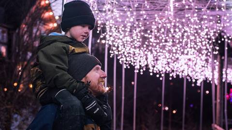 A father and son exploring Holiday Magic at Blue