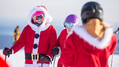 A group of skiers dressed up as Santa Clause