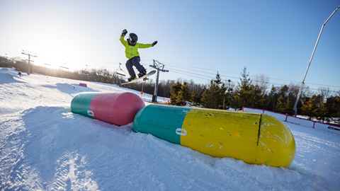 A person doing a trick on a snowboard.