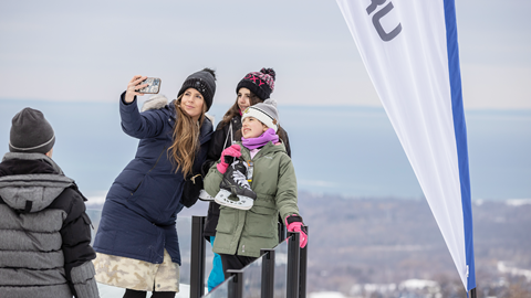 A group of people taking a picture on a ski slope.