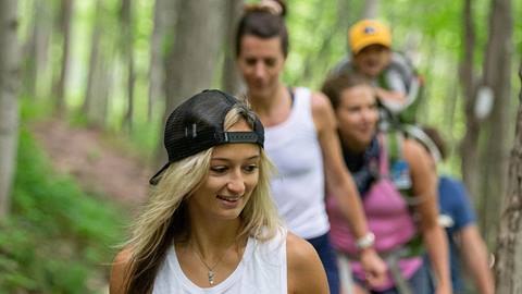 a person leading a group on a hiking trail at blue mountain resort