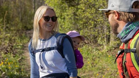 a person with a toddler on a hiking trail conversing with another person at blue mountain resort